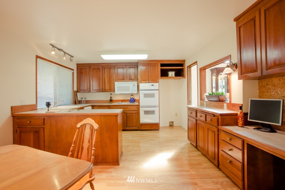 5558 West Mercer Way Mercer Island, WA 98040 - Photo 7 of 20 a large kitchen with stainless steel appliances granite countertop a stove a sink a refrigerator and a refrigerator