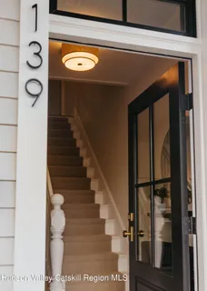 a kitchen with a stove a sink a dining table and chairs