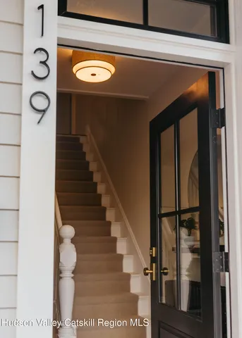a kitchen with a stove a sink a dining table and chairs