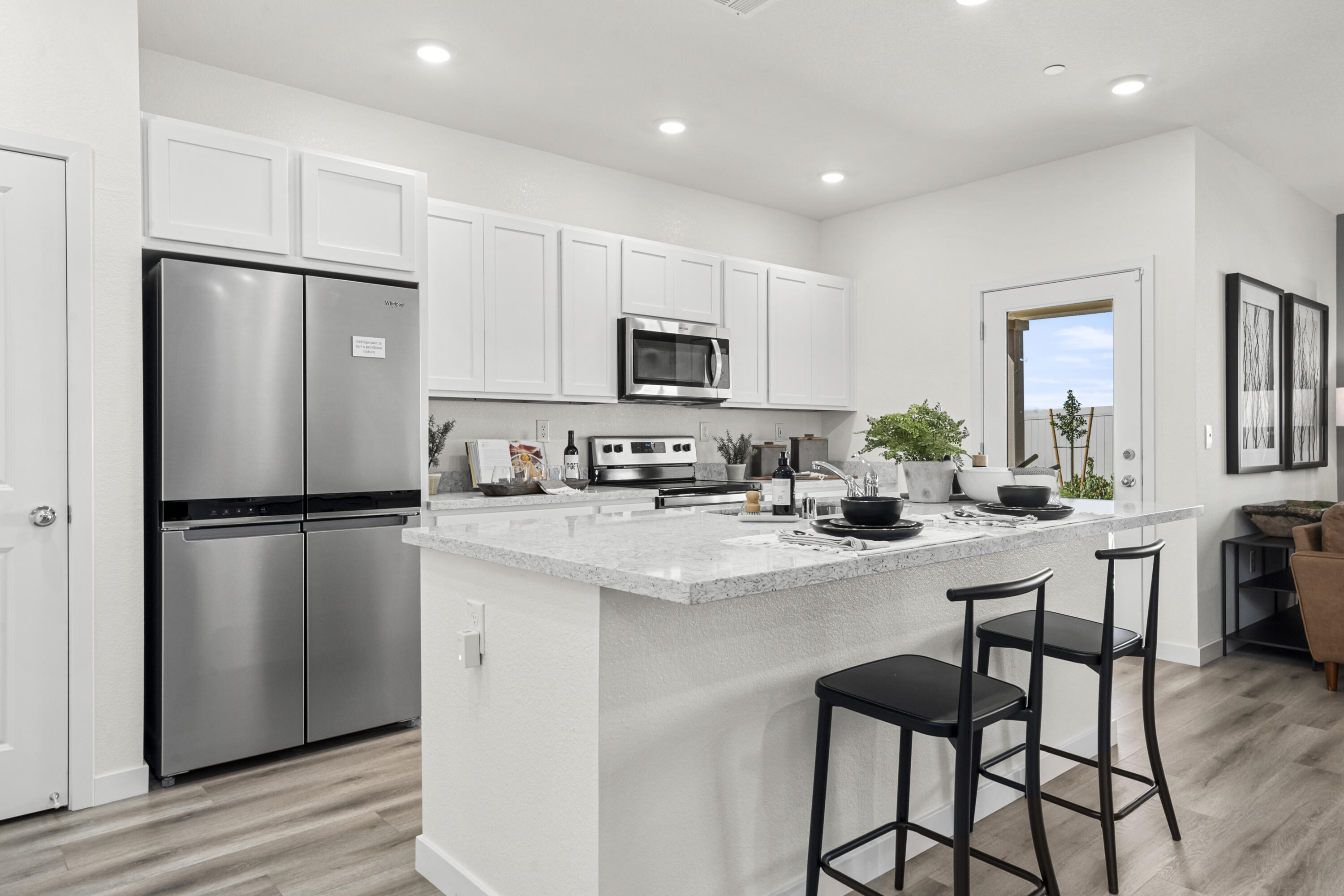 5240 Monaco Parkway Redding, CA 96002 - Photo 3 of 7 a kitchen with refrigerator a microwave and cabinets