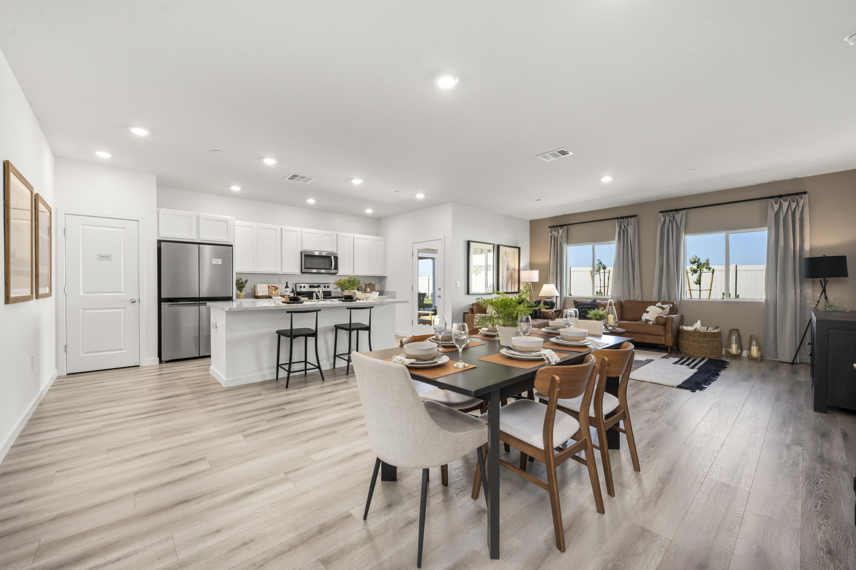 5240 Monaco Parkway Redding, CA 96002 - Photo 4 of 7 a living room with lots of furniture and kitchen view with wooden floor