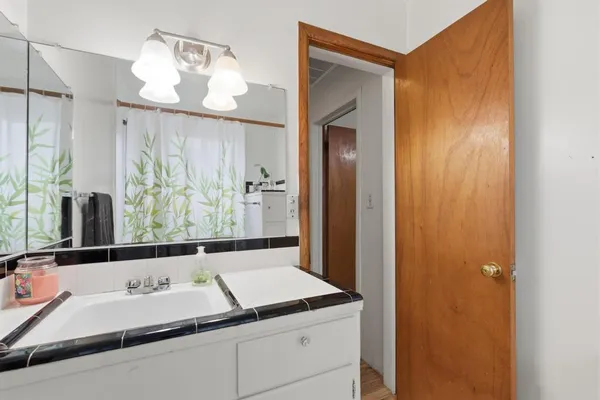 a bathroom with a sink and a mirror