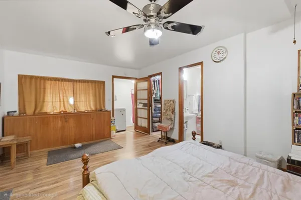 a spacious bedroom with a large bed and a window