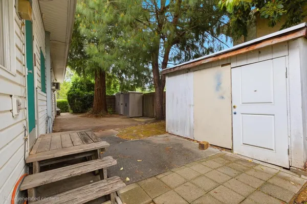 a backyard of a house with portable trees and entryway