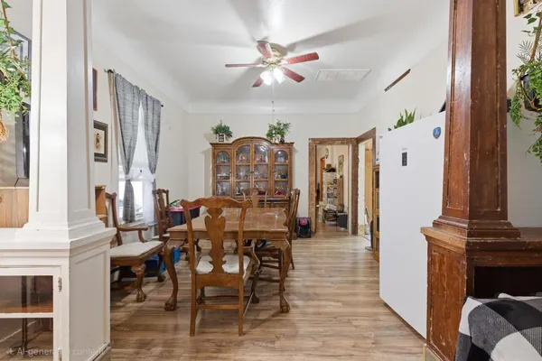 a view of a dining room with furniture and a chandelier fan