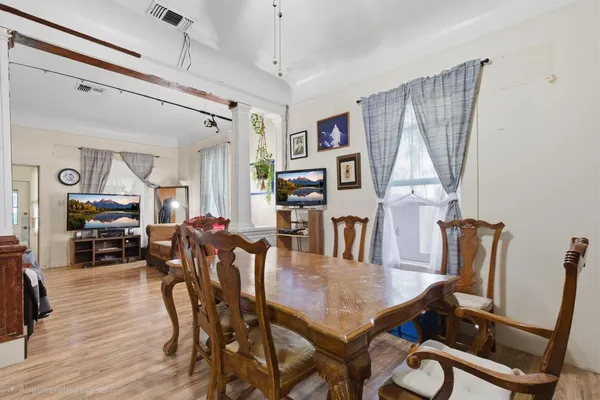 a view of a dining room with furniture and wooden floor