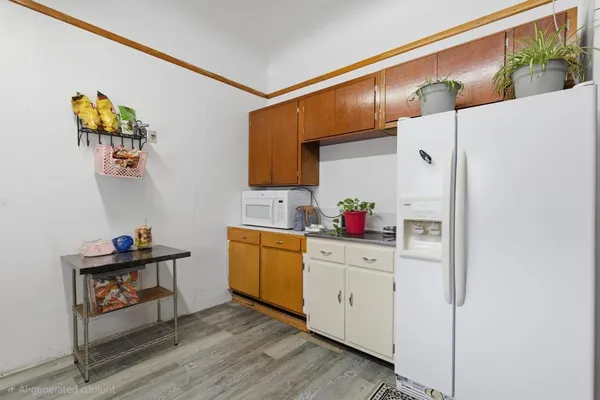 a kitchen with a refrigerator and sink