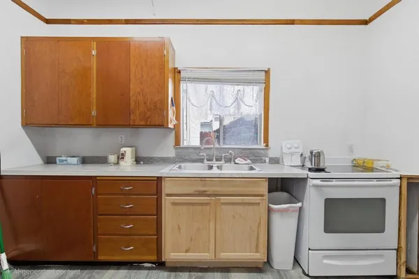 a kitchen with a sink a stove and cabinets