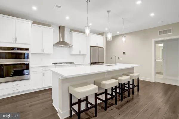 a large kitchen with a table and chairs in it