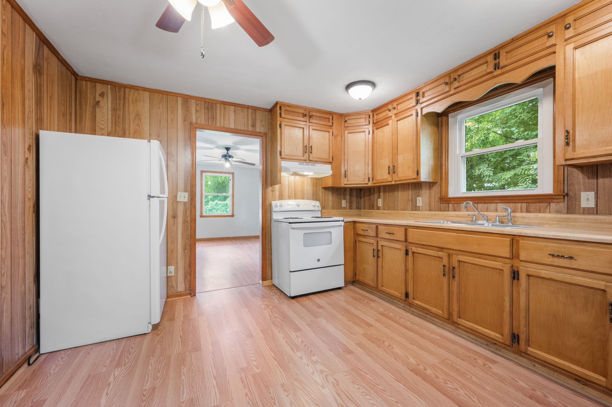 109 Riverside Drive Centerville, TN 37033 - Photo 15 of 29 a kitchen with a white cabinets a sink a window and stainless steel appliances