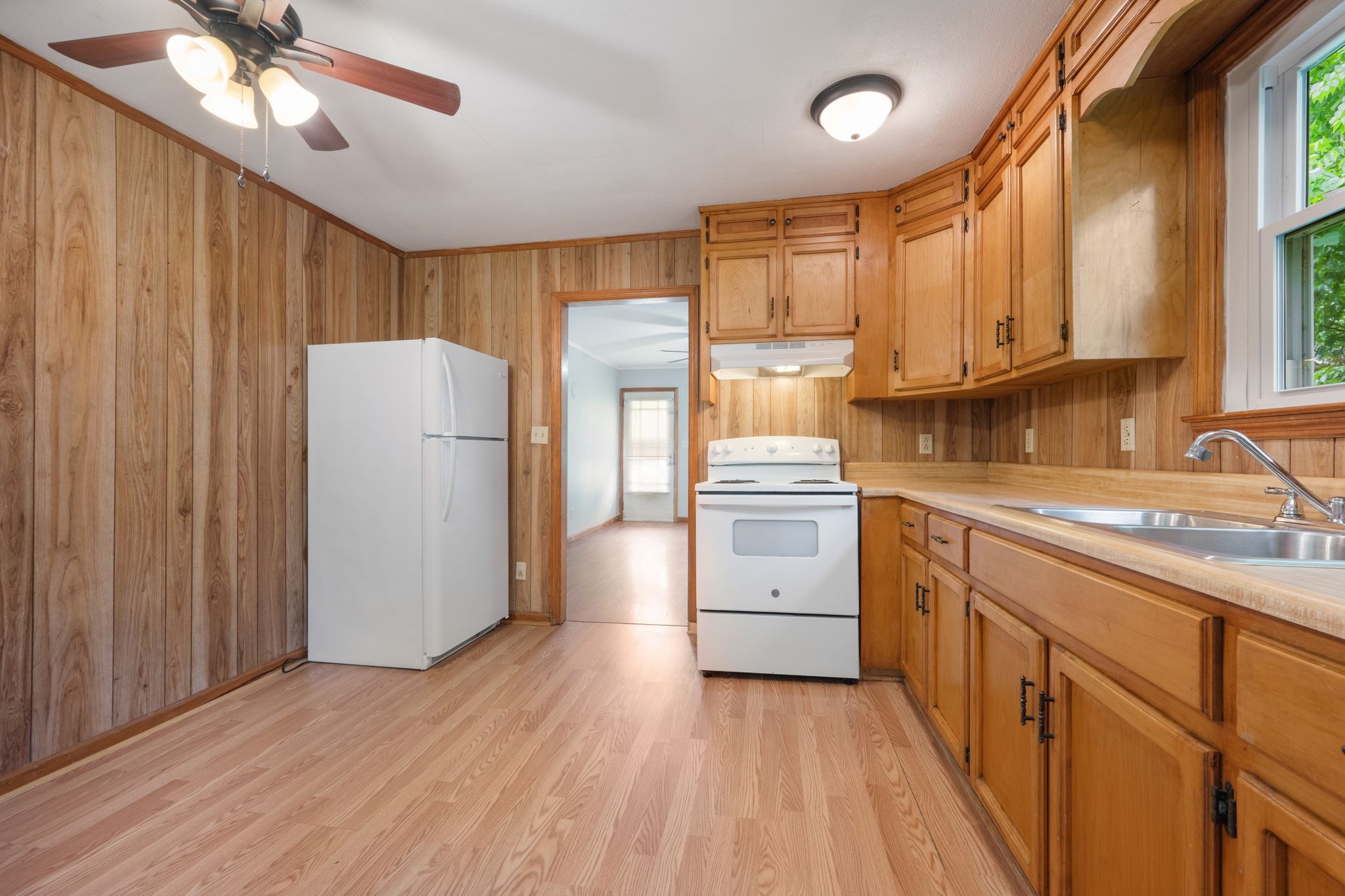 109 Riverside Drive Centerville, TN 37033 - Photo 16 of 29 a kitchen with a refrigerator a sink and dishwasher with wooden floor