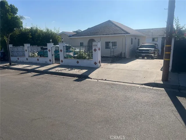 a view of a white house with a yard and garage