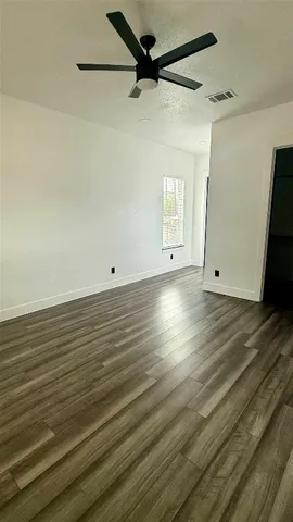 a view of room with window and wooden floor