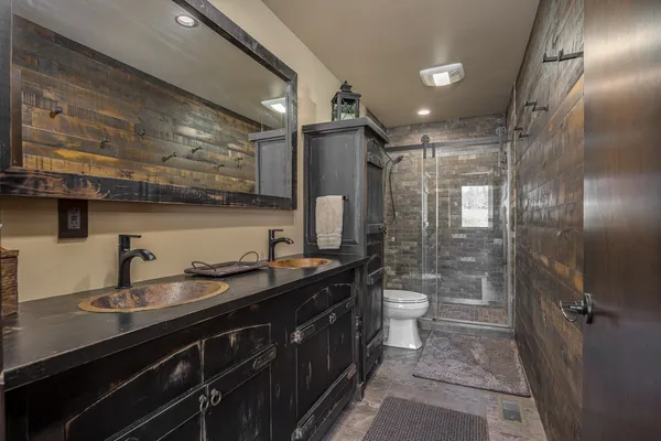 a bathroom with a sink a toilet and shower