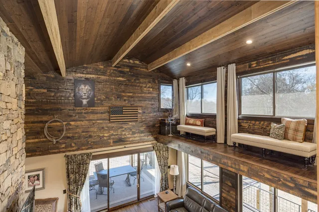 a spacious bedroom with a bed and a chandelier