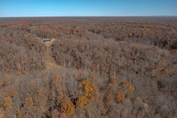 a front view of a house with a yard covered in snow