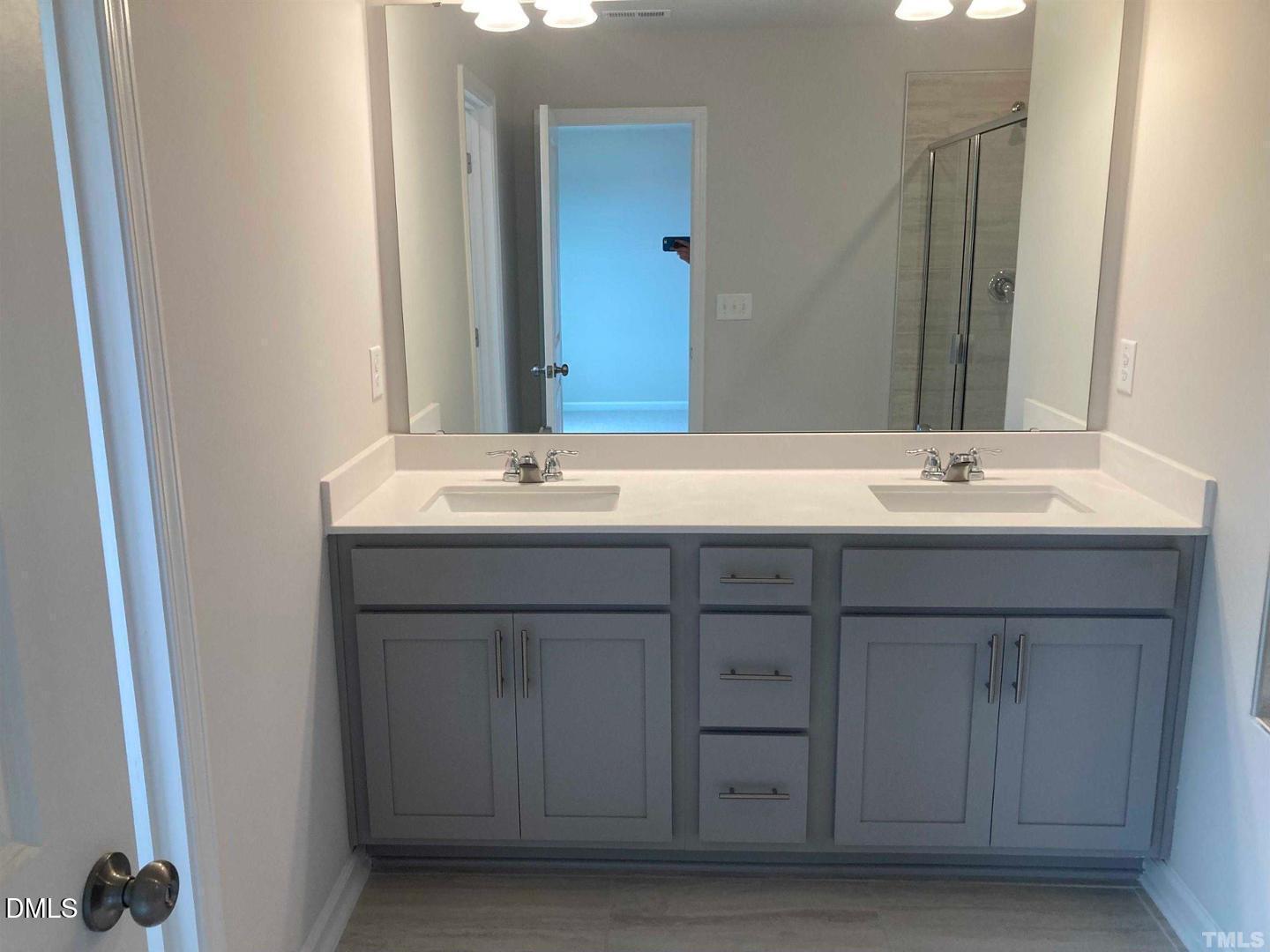 1823 Caen Street Raleigh, NC 27610 - Photo 10 of 13 a bathroom with a sink and a mirror