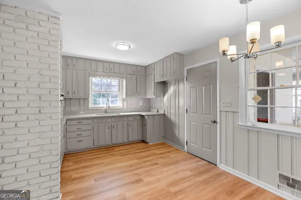 a large kitchen with kitchen island a sink stainless steel appliances and window