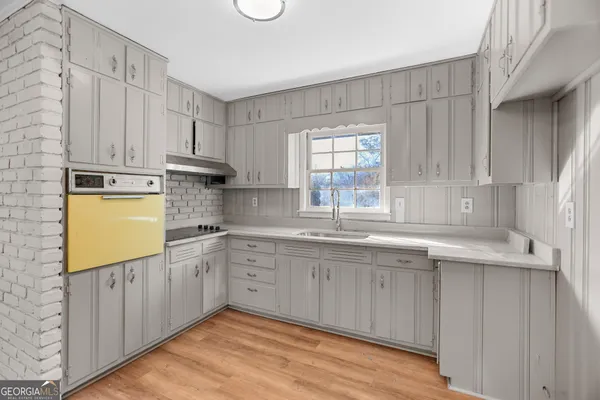 a kitchen with stainless steel appliances granite countertop a sink stove and cabinets