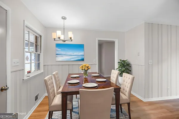 a view of a dining room with furniture window and wooden floor