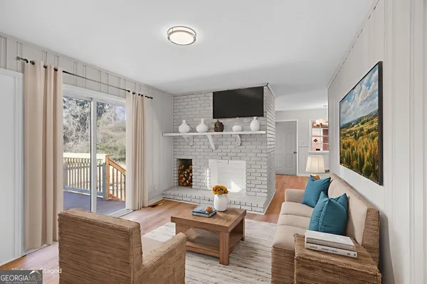 a living room with furniture a flat screen tv and a fireplace