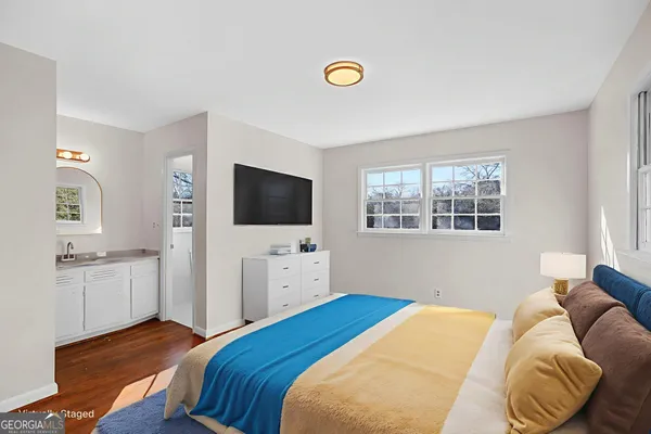 a bedroom with a bed and a flat screen tv