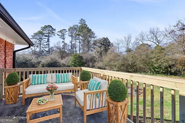 a view of a chair and table on the roof deck