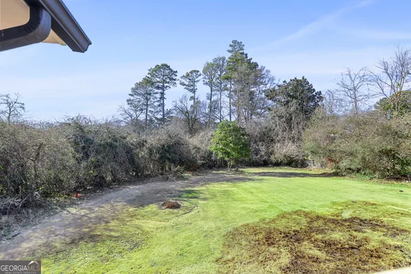 a view of a swimming pool with a yard