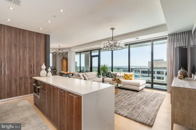a large kitchen with kitchen island a large window in it