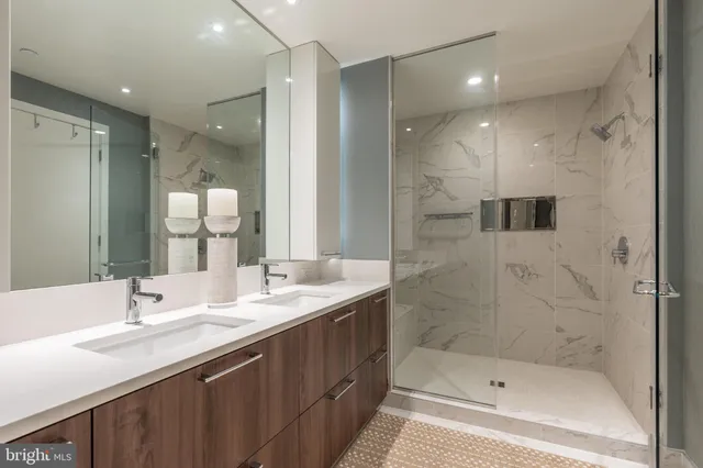 a bathroom with a bathtub shower sink double and mirror