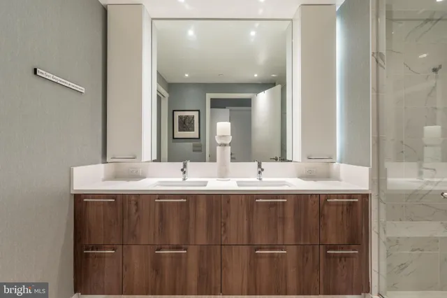 a bathroom with a double vanity sink and mirror