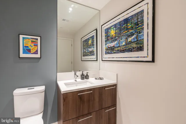 a bathroom with a sink a toilet and a mirror