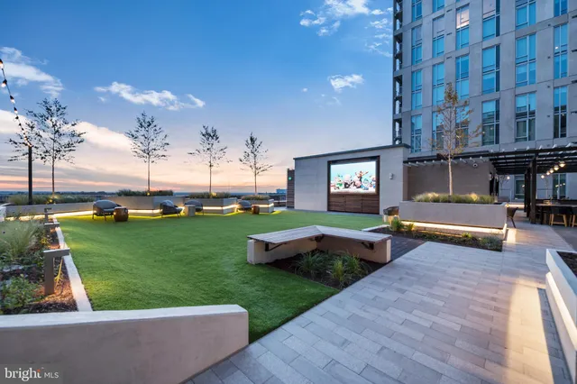 a view of a swimming pool with outdoor seating