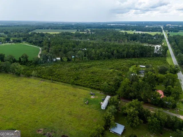 a view of a garden with a building in the background