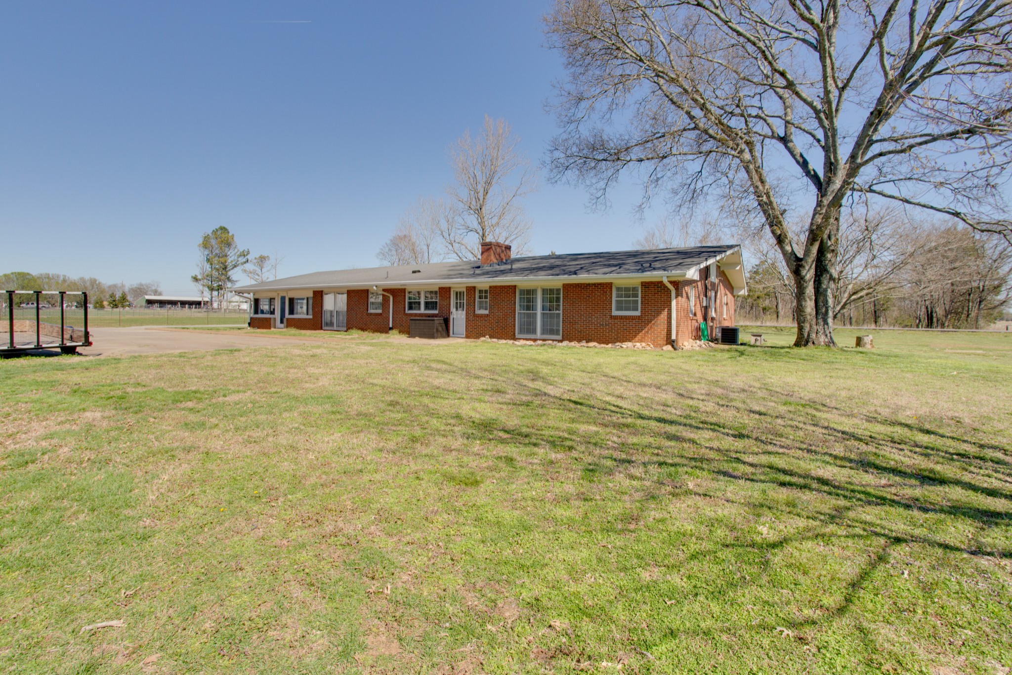350 Flat Woods Road Lebanon, TN 37090 - Photo 32 of 33 a view of a large building next to a yard with large trees