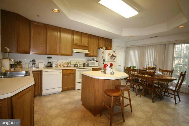 333 Colony Point Place Edgewater, MD 21037 - Photo 1 of 11 a kitchen with a sink dining table and chairs
