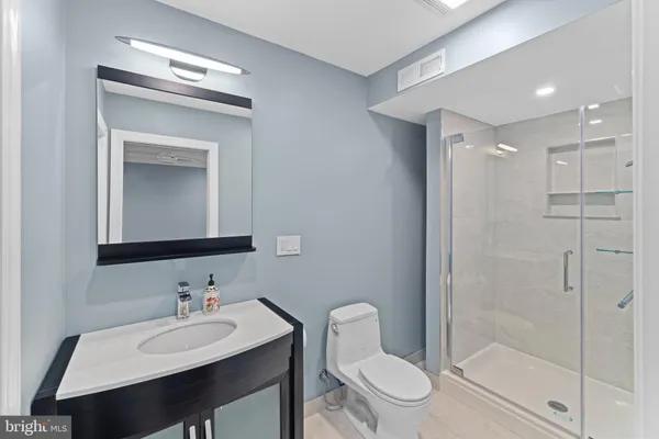 an empty room with wooden floor and natural light