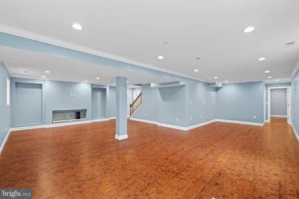 a view of empty room with wooden floor