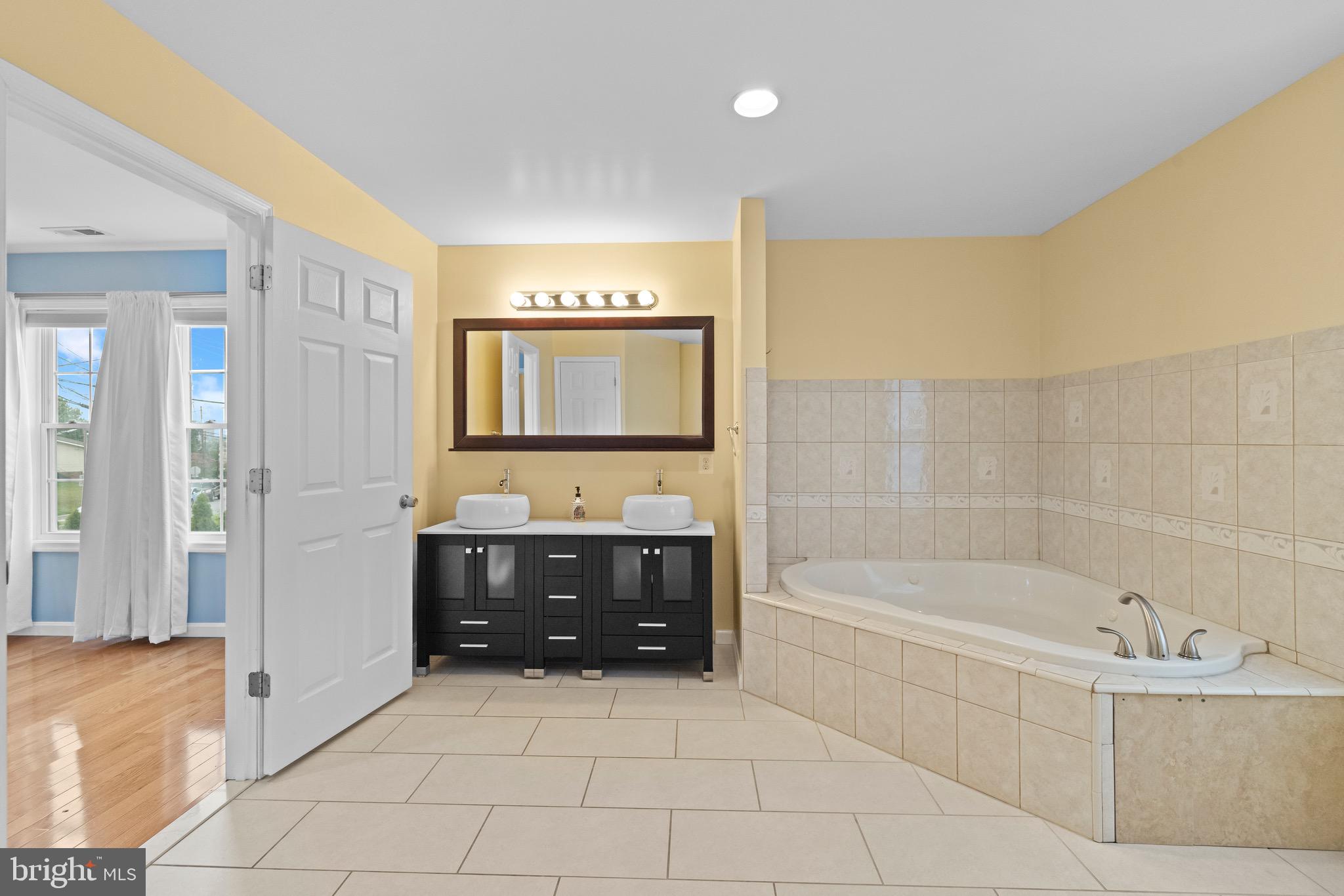 5402 Odell Road Beltsville, MD 20705 - Photo 31 of 69 a bathroom with a bathtub and a sink