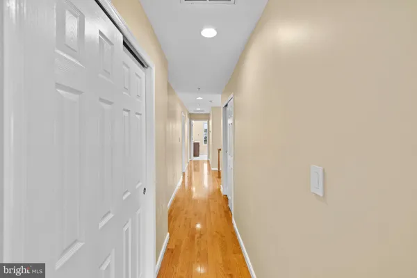 a view of a big room with wooden floor and windows in a room