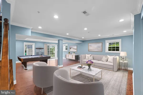 a living room with fireplace furniture and a wooden floor