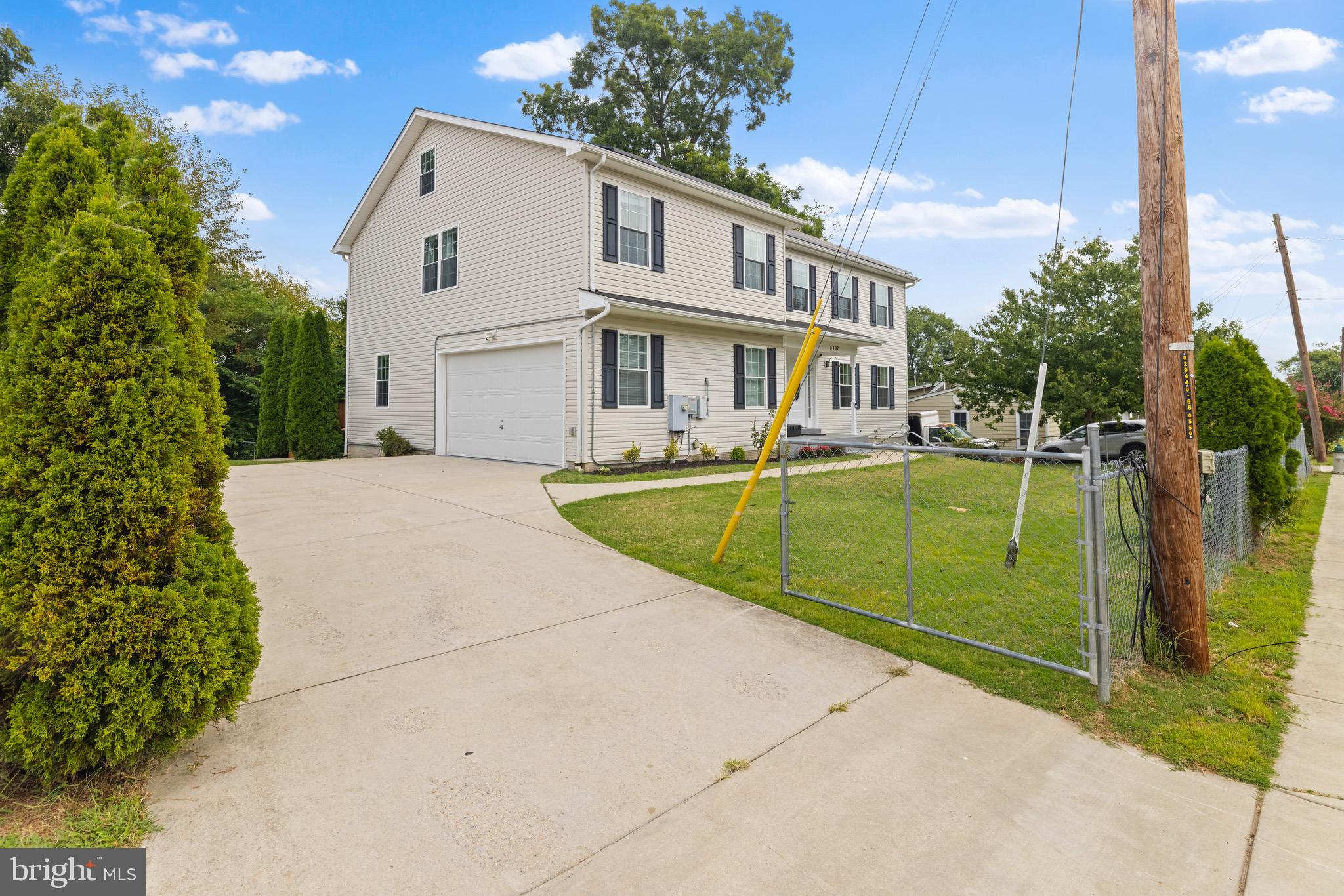 5402 Odell Road Beltsville, MD 20705 - Photo 6 of 69 a view of a white house with a big yard and potted plants