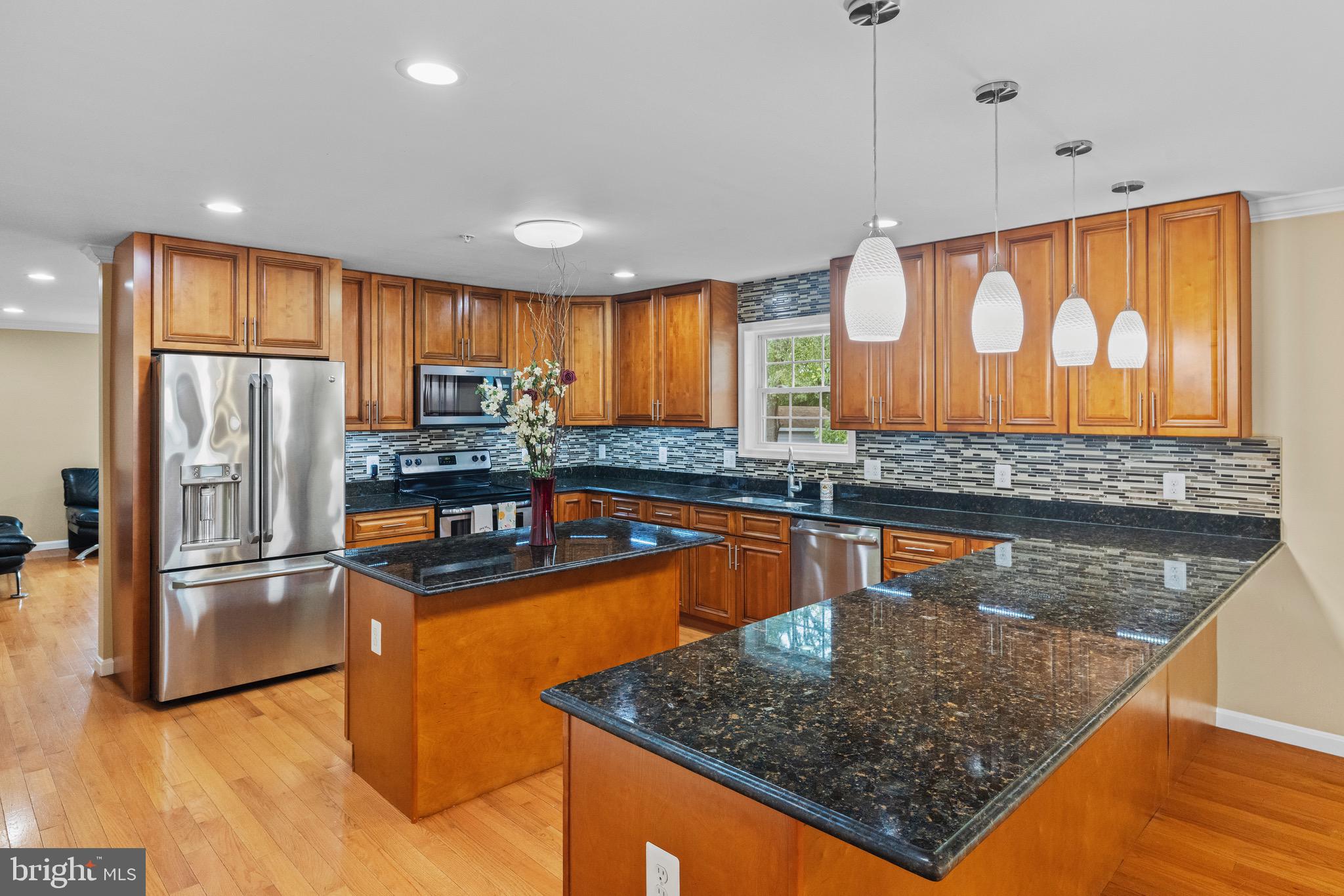 5402 Odell Road Beltsville, MD 20705 - Photo 8 of 69 a kitchen with stainless steel appliances granite countertop a sink a stove and a refrigerator
