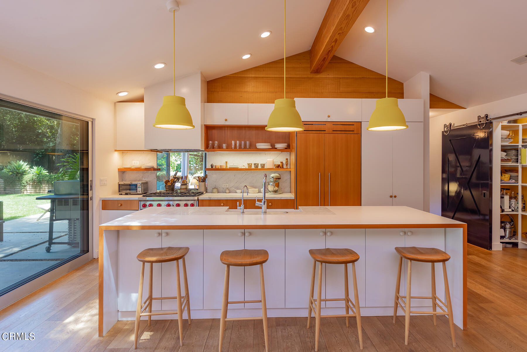 712 Cuyama Road Ojai, CA 93023 - Photo 15 of 50 a kitchen with stainless steel appliances granite countertop a table chairs sink and wooden cabinets