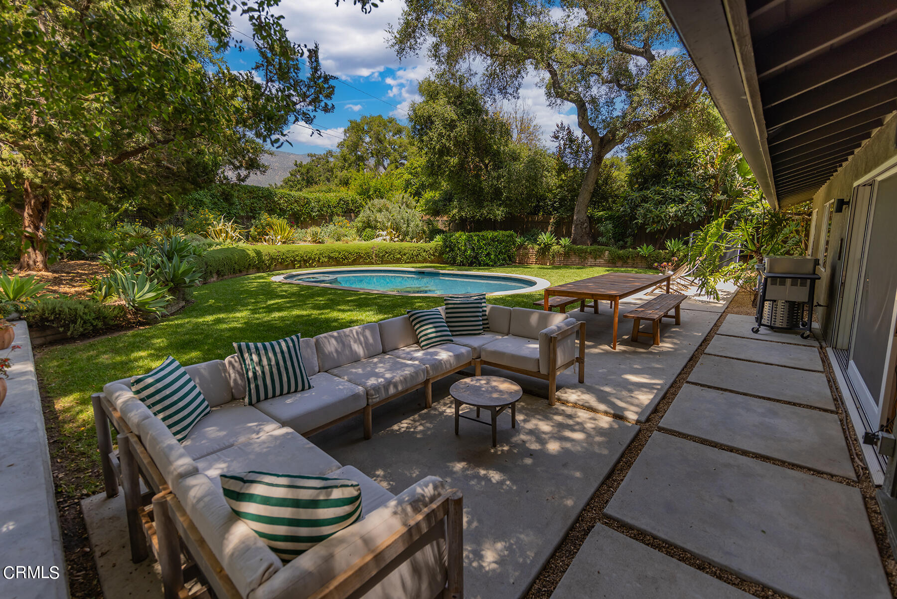 712 Cuyama Road Ojai, CA 93023 - Photo 3 of 50 a view of a patio with couches table and chairs and potted plants