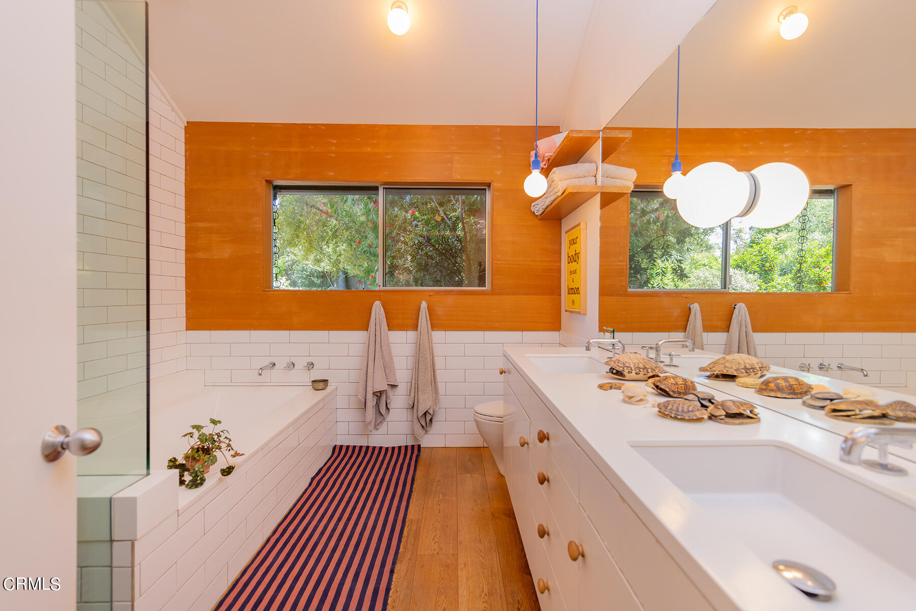 712 Cuyama Road Ojai, CA 93023 - Photo 31 of 50 a bathroom with a sink mirror and a bathtub with windows