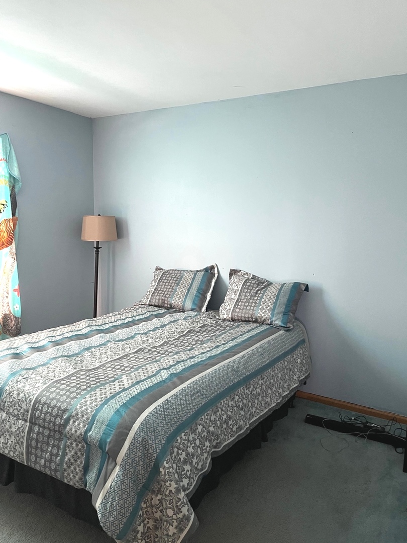 341 Richfield Trail Romeoville, IL 60446 - Photo 8 of 8 a bedroom with a bed and a lamp