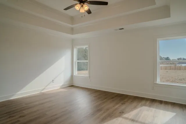 wooden floor in an empty room with a window