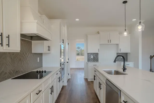 a kitchen with stainless steel appliances a sink stove and refrigerator