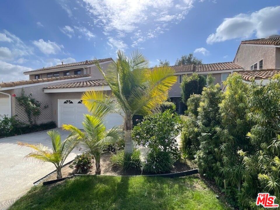 a view of a swimming pool with a yard and a garden